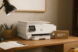 an hp printer and ink on a desk 