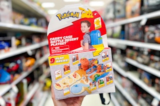 Pokemon Desert Playset with backpack carrying case held up in toy isle at Target