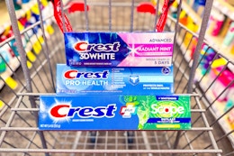3 tubes of crest toothpaste in a cart