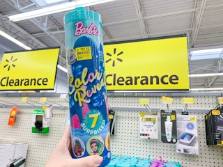 barbie color reveal surprise mermaid doll in tube with clearance price tag held up in front of walmart clearance signs