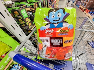 large bag of halloween candy in a cart including kit kat, reeses, hersheys and milk duds