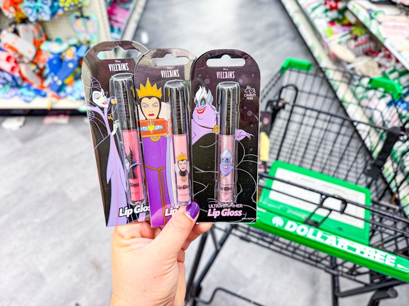 person holding disney villains lip glosses by a dollar tree cart