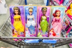 Belle, Cinderella, Tiana, and Ariel Disney Princess dolls in a Walmart cart