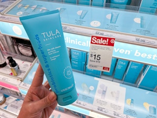 hand holding a bottle of tula cult classic cleanser in front of a target tag