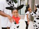 family wearing cow costumes for chick-fil-a cow appreciation day