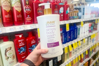 hand holding bottle of raw sugar body wash