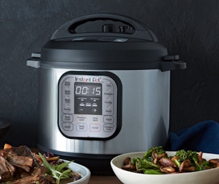 a mini Instant Pot on a table with bowls of food