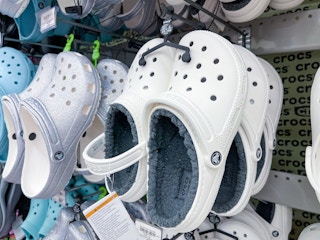 academy crocs white fleece lined hanging on rack