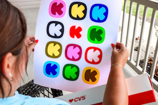 person holding photo poster with krazy coupon lady logos