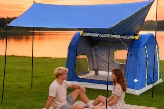 Couple using the  Eolzzi 2-4 Person Inflatable Camping Tent outside at sunset.