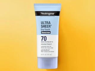 a tube of sunscreen on a yellow background
