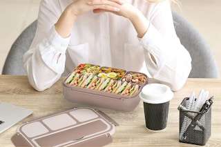 Person enjoy bento box on desk during lunch