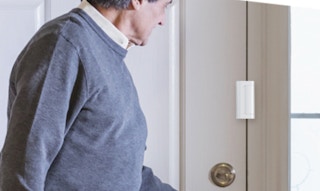 a person opening a door with a reinforcement lock