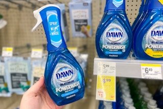 hand holding a bottle of dawn powerwash dish spray by a walgreens sale tag