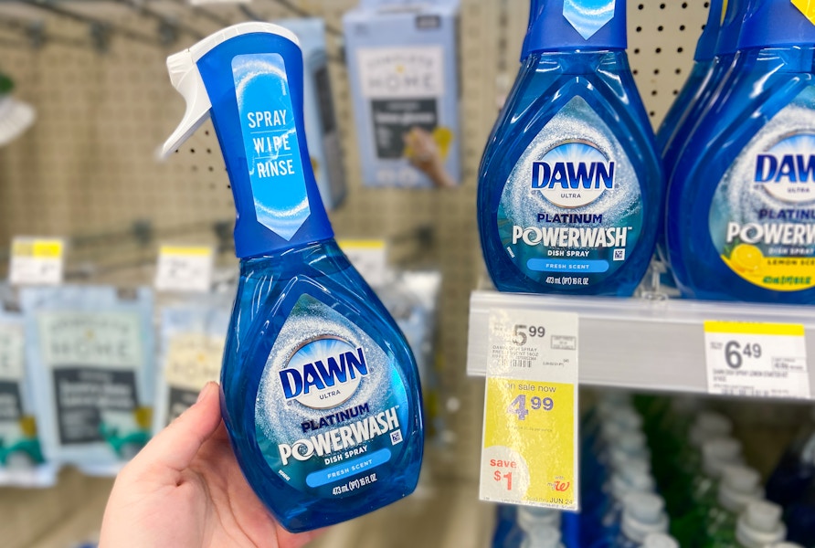 hand holding a bottle of dawn powerwash dish spray by a walgreens sale tag