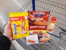 Nesquik Strawberry Mix held over Walmart shopping cart. The cart is full of Digiorno, Coffee Mate, Lean Cuisine, Stouffers, and Nestle ...