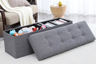 a storage ottoman in a room 