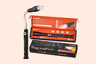 a person working on a car using a magnetic flashlight tool