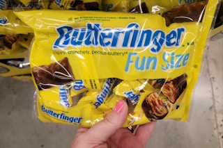 hand holding a bag of butterfinger fun size candy