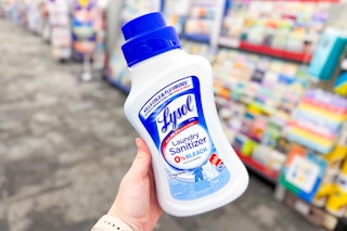 person holding a bottle of lysol laundry sanitizer