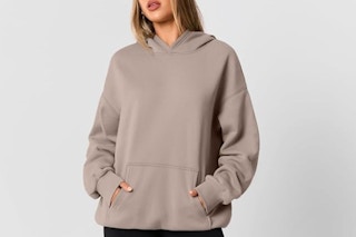 a woman wearing an oversized hoodie