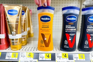 hand touching a bottle of vaseline lotion