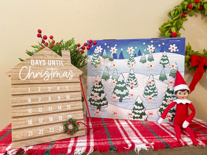 elf on the shelf doll sitting in front of playdoh advent calendar and christmas count down 