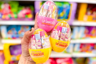 Lip Smacker Easter Lip Balm Sets, 3 held up in front of easter candy at Target