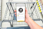 hand holding a smartphone displaying a 1-clip coupon in the kcl app