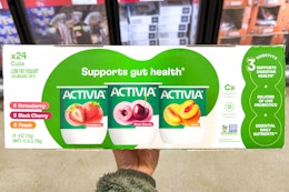 hand holding a box of activia yogurt