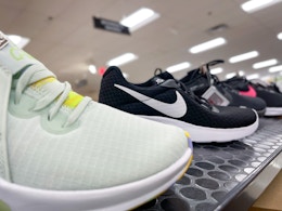 A variety of Nike shoes sitting on a store shelf.