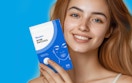 a person holding a pack of pimple patches