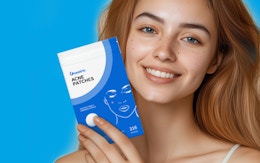 a person holding a pack of pimple patches