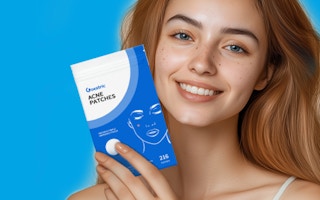 a person holding a pack of pimple patches