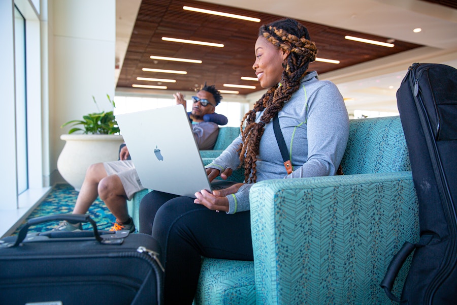 Person sitting down while typing on a laptop