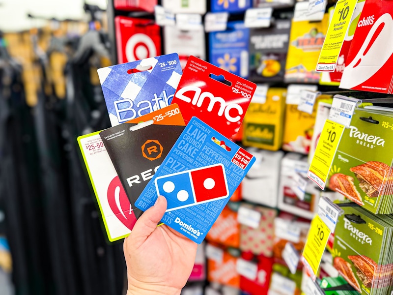 person holding a handful of gift cards