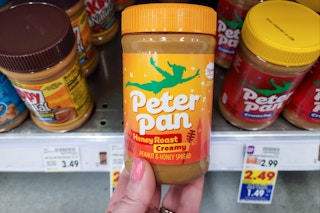 hand holding a jar of peter pan peanut butter at kroger