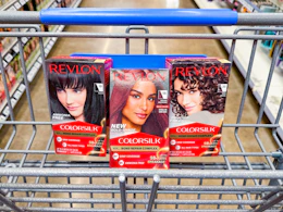 3 revlon hair color boxes sitting in a walmart cart