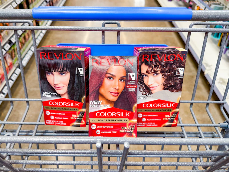 3 revlon hair color boxes sitting in a walmart cart