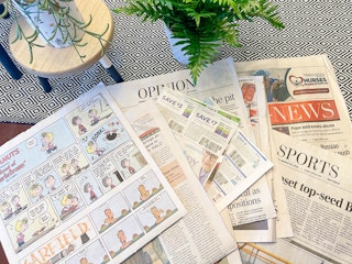 multiple newspapers spread out