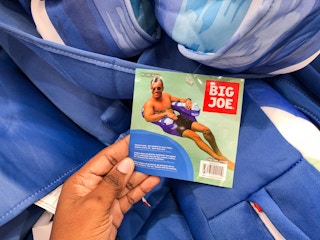 hand holding the tag for a big joe noodle chair