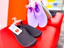 two pairs of water shoes on target bench