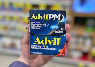 hand holding two Advil boxes