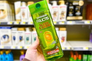 hand holding garnier fructis shampoo at dollar general