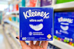hand holding kleenex ultra soft tissues in walgreens