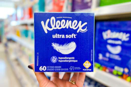 hand holding kleenex ultra soft tissues in walgreens