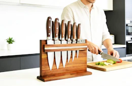 knives on a wooden magnetic holder on a kitchen counter