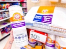 hand holding an arm & hammer down pillow in front of a target shelf