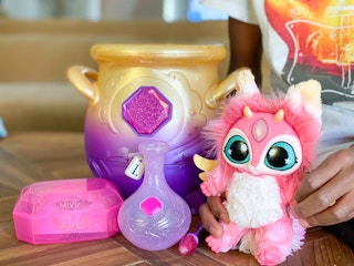 The Magic Mixies misting cauldron toy set placed on a table.