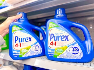 hand pulling a bottle of Purex detergent off a Walmart shelf